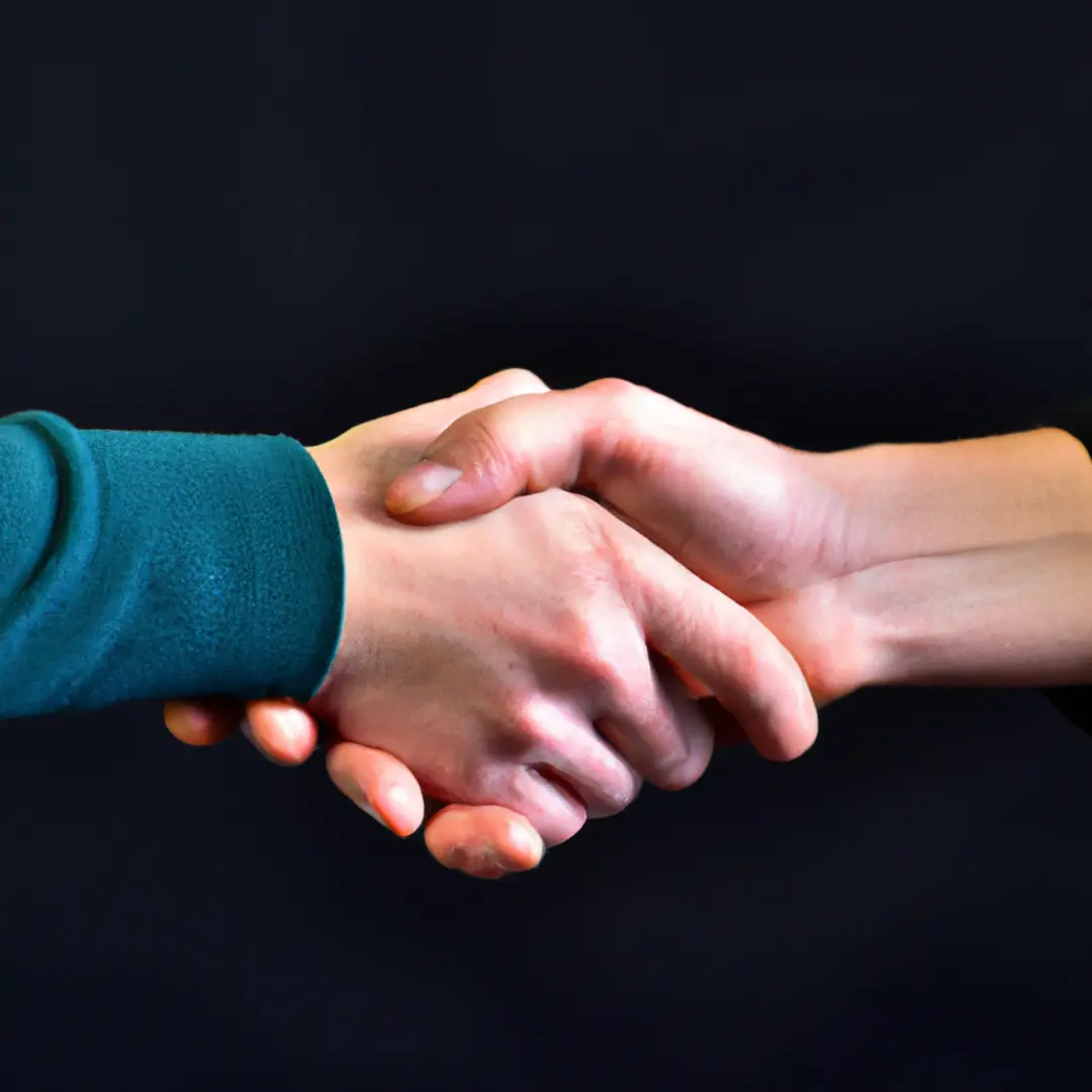 Two hands shaking symbolizing successful dispute resolution with legal counsel for startups.