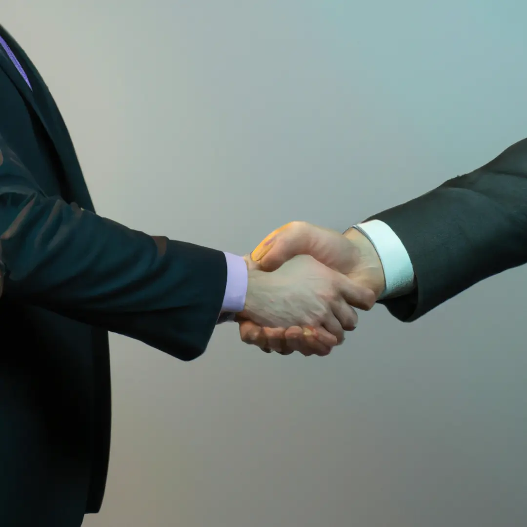 A handshake between two people representing a business partnership.